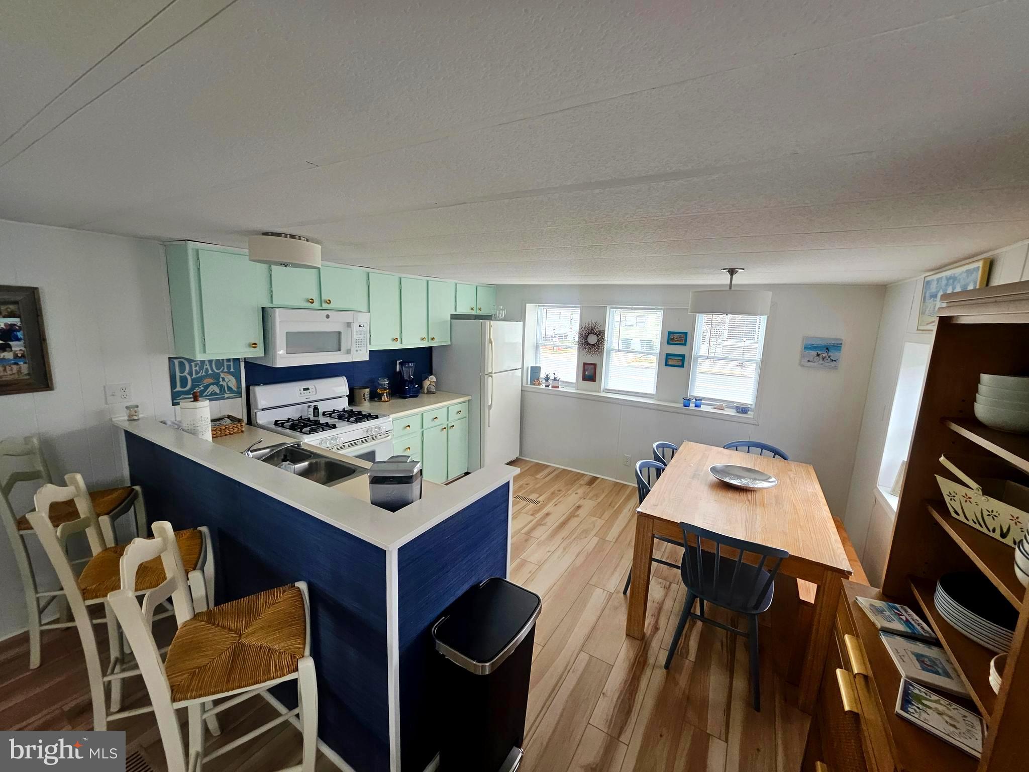 160 Clamshell Road Ocean City, MD 21842 - Photo 7 of 32 a view of a dining room with furniture and wooden floor