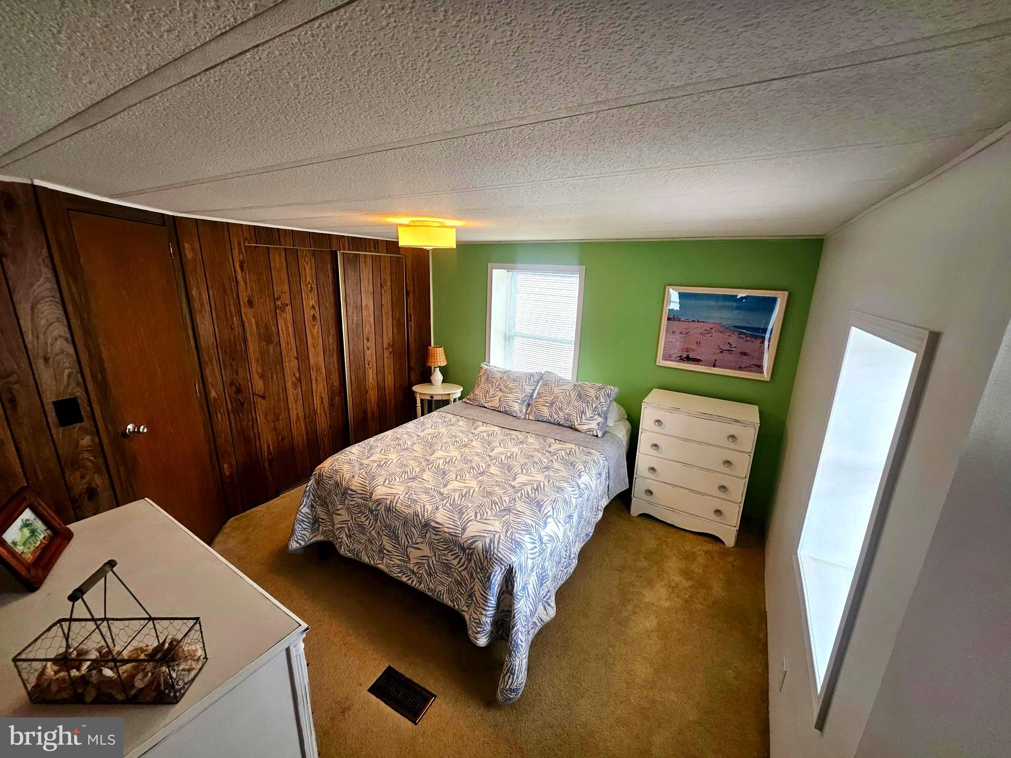 160 Clamshell Road Ocean City, MD 21842 - Photo 8 of 32 a bedroom with a bed and a dresser