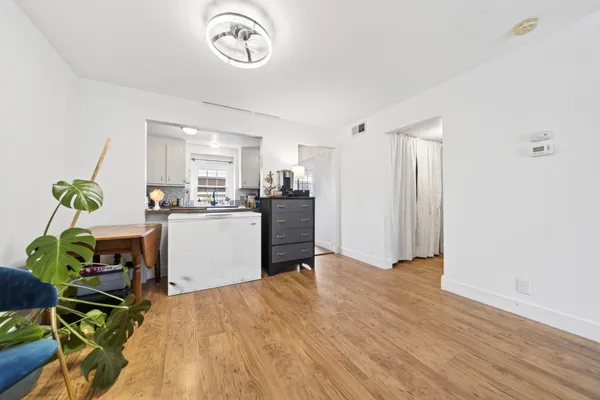 a view of a house with a big yard plants and large trees