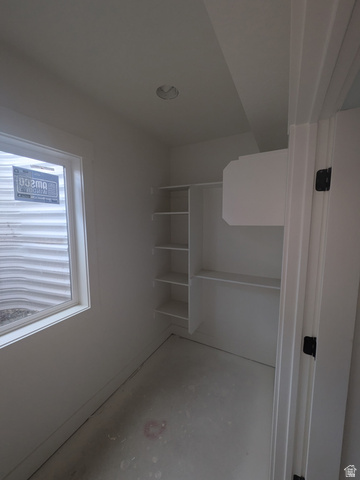 2771 West Aurora Avenue Mapleton, UT 84664 - Photo 33 of 39 Recessed lighting illuminating a storage area with built-in shelving, a window, and a white trim door frame with matte black hardware