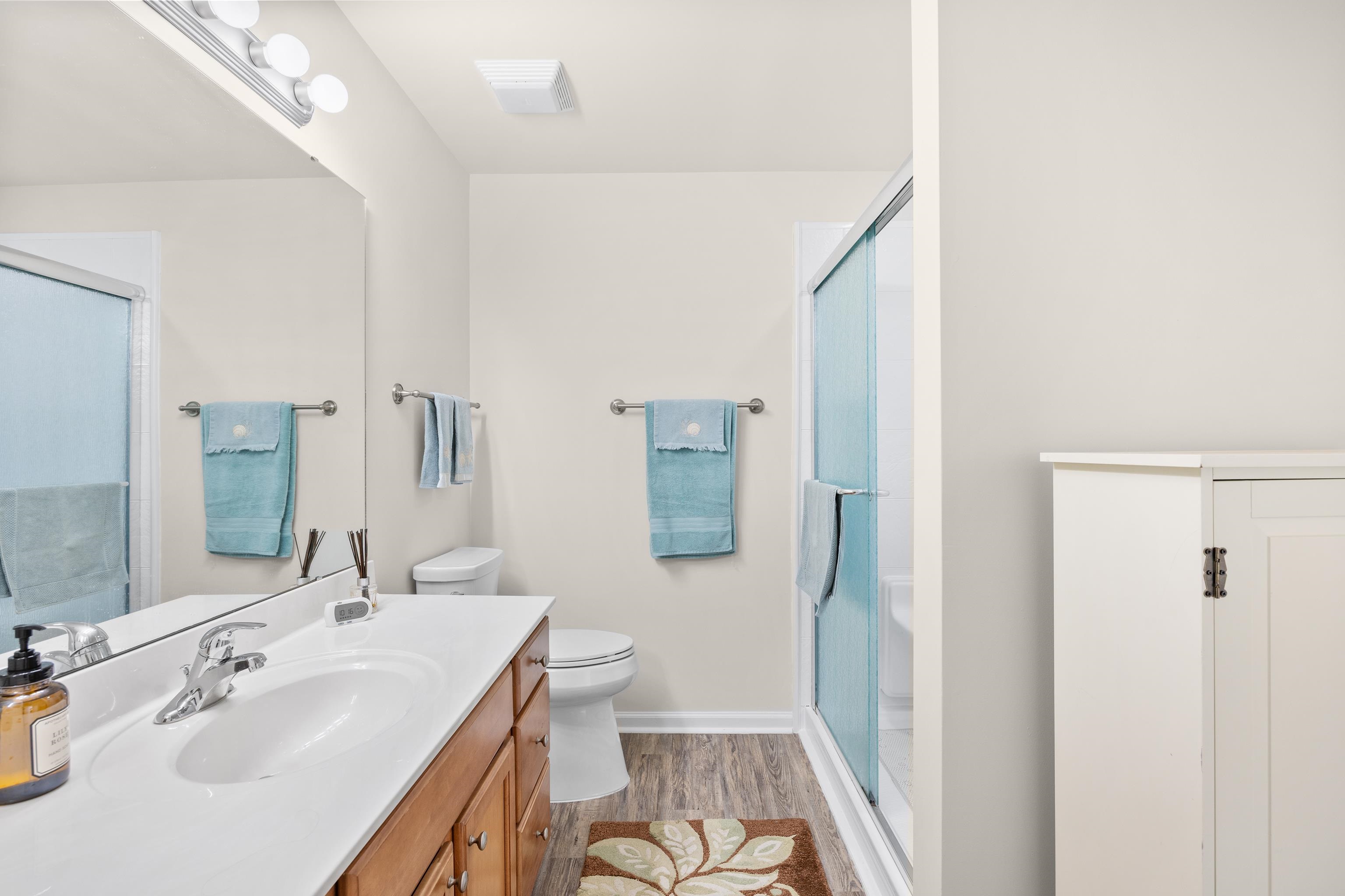 340 Arlington Circle, Unit 340 Murrells Inlet, SC 29576 - Photo 19 of 39 New shower with a sliding glass door enclosure, vanity with sink, linen closet, and new high-rise toilet.