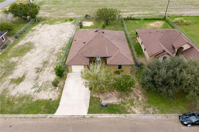 an aerial view of a house with garden space and lake view