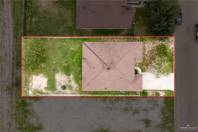 an aerial view of a house and a yard