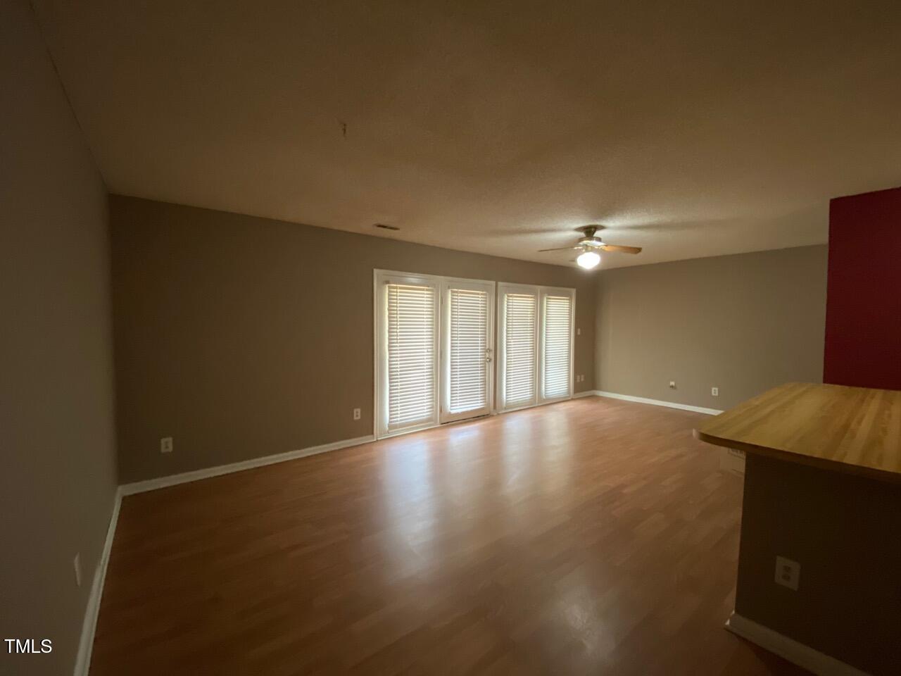 2011 Quaker Landing, Unit 102 Raleigh, NC 27603 - Photo 3 of 12 a view of an empty room with window and wooden floor