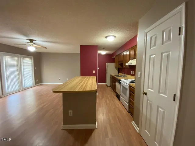 a view of a kitchen with a sink and cabinets