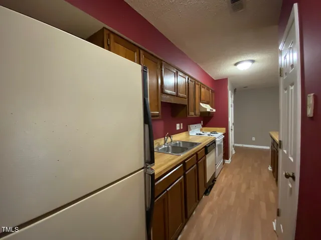 a kitchen with stainless steel appliances a stove and a refrigerator