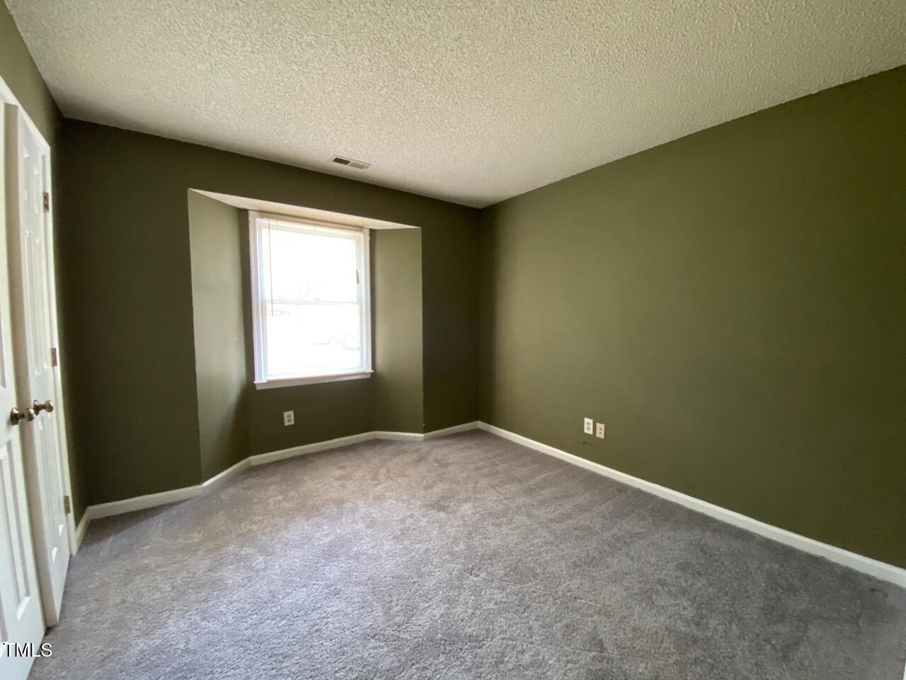 2011 Quaker Landing, Unit 102 Raleigh, NC 27603 - Photo 7 of 12 an empty room with windows