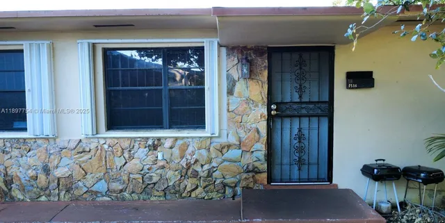 a view of backyard of house with green space