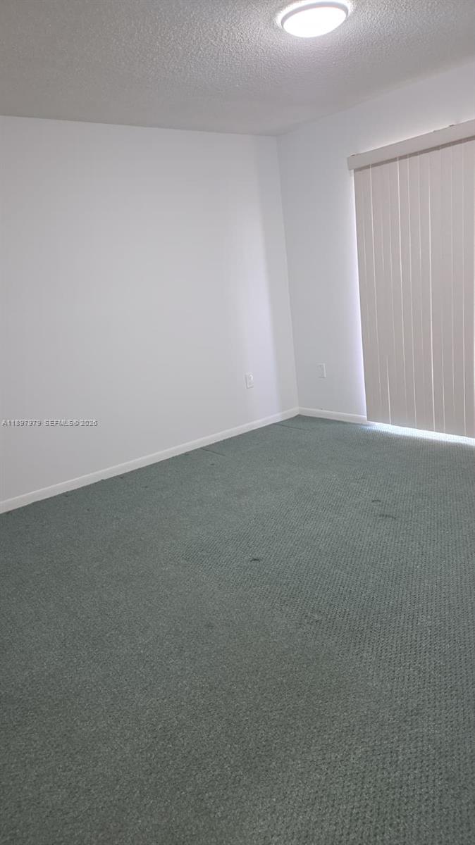 5249 Northwest 7th Street, Unit 418 Miami, FL 33126 - Photo 14 of 25 a view of an empty room and a window