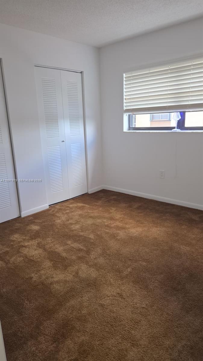 5249 Northwest 7th Street, Unit 418 Miami, FL 33126 - Photo 20 of 25 an empty room with a window