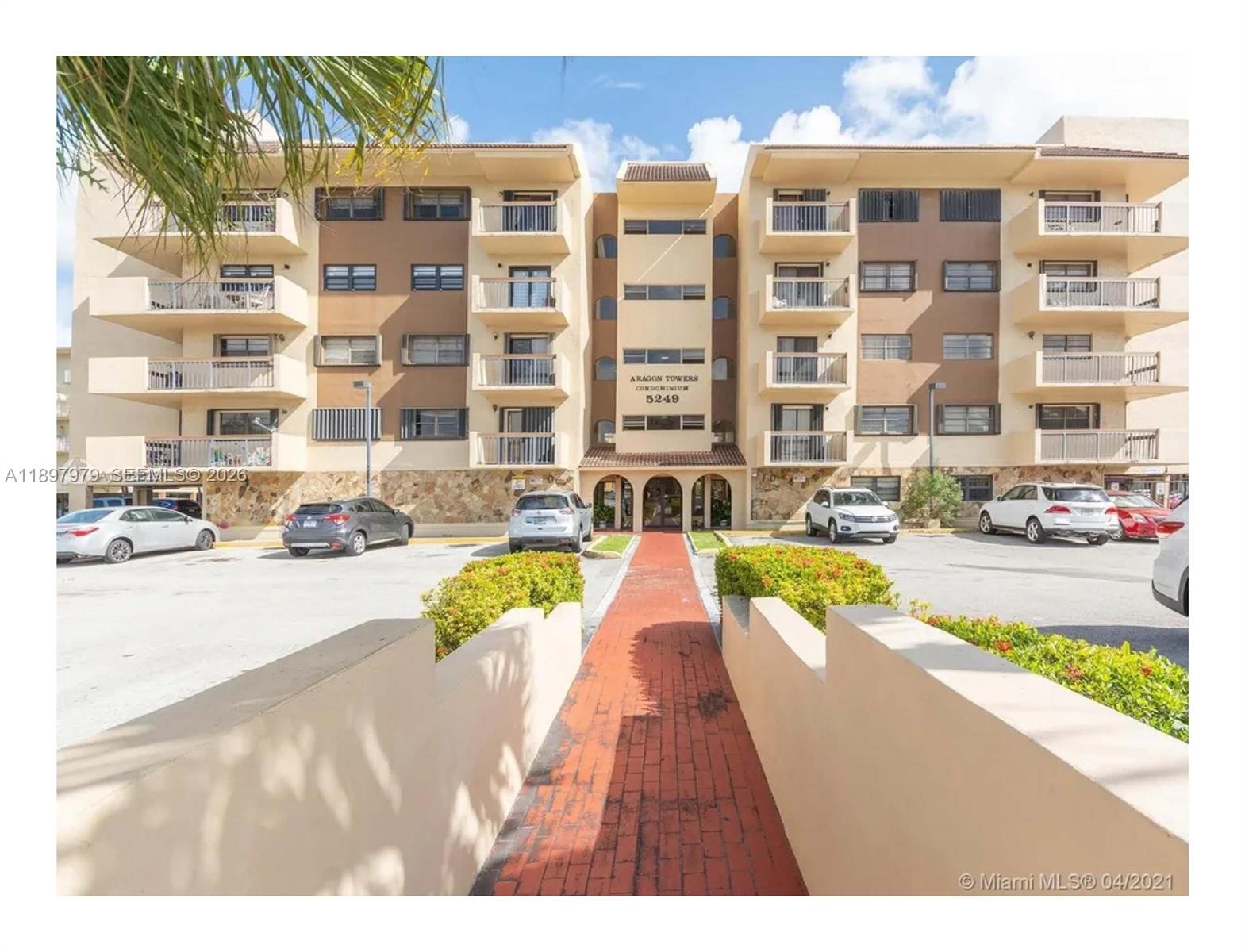 5249 Northwest 7th Street, Unit 418 Miami, FL 33126 - Photo 2 of 25 a swimming pool with outdoor seating and yard