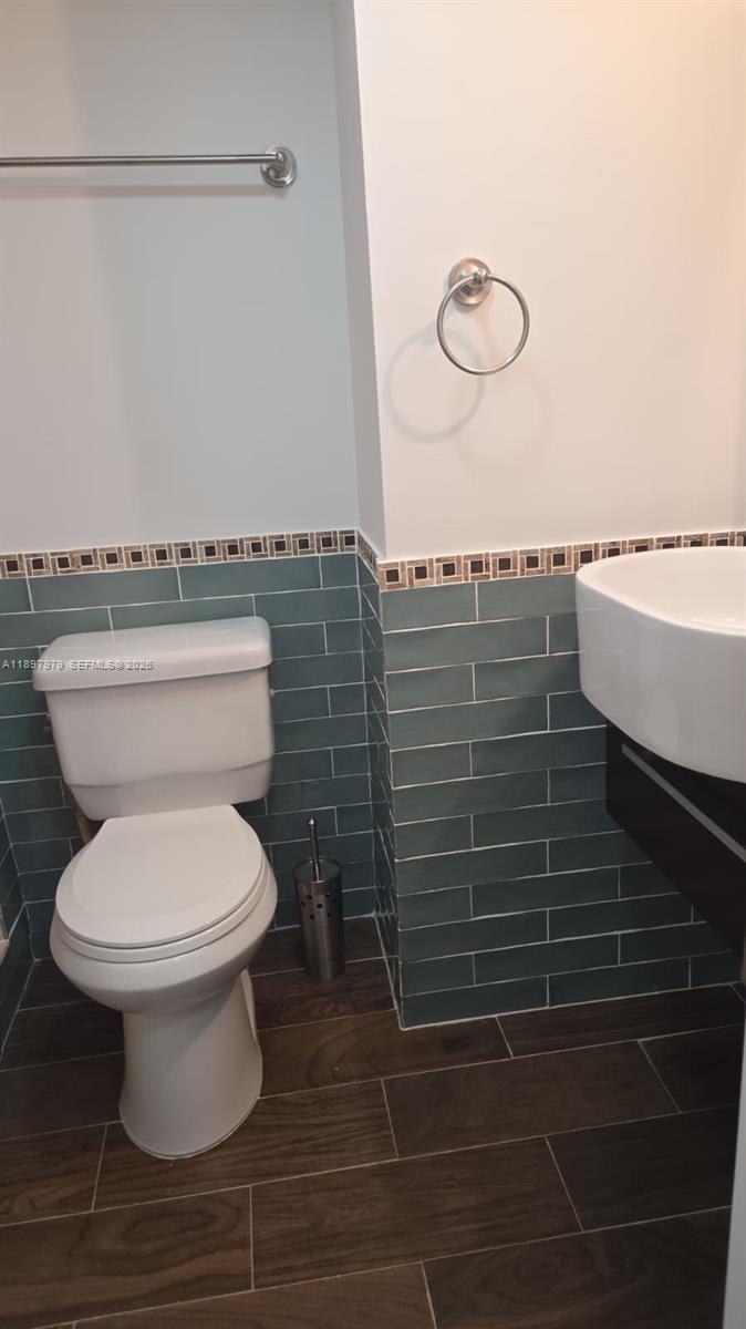 5249 Northwest 7th Street, Unit 418 Miami, FL 33126 - Photo 23 of 25 a bathroom with a toilet and a sink