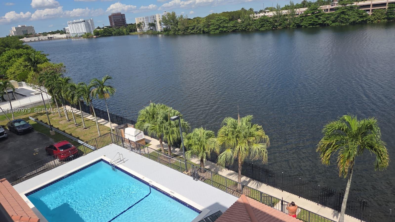 5249 Northwest 7th Street, Unit 418 Miami, FL 33126 - Photo 4 of 25 a view of a lake with large trees