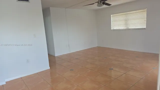 a view of an empty room and a window