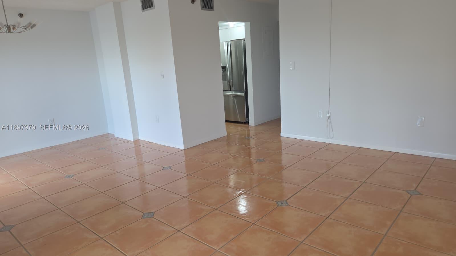 5249 Northwest 7th Street, Unit 418 Miami, FL 33126 - Photo 6 of 25 an empty room with white walls