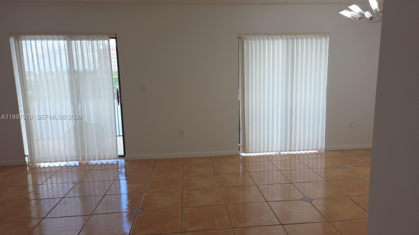 5249 Northwest 7th Street, Unit 418 Miami, FL 33126 - Photo 7 of 25 a view of an empty room with a window
