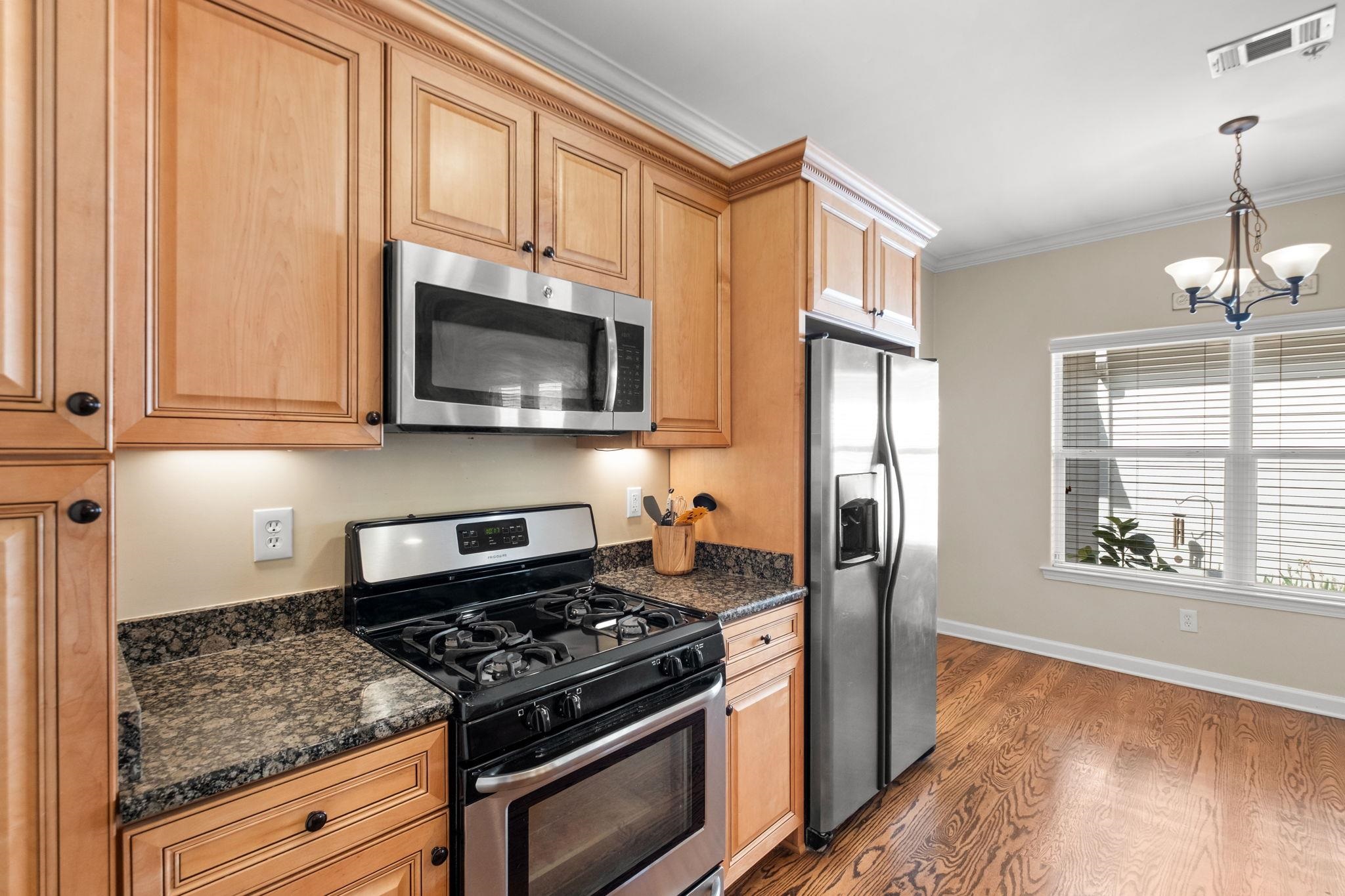 2275 McVay Road, Unit 2275 Germantown, TN 38138 - Photo 7 of 40 a kitchen with stainless steel appliances granite countertop a stove microwave and refrigerator