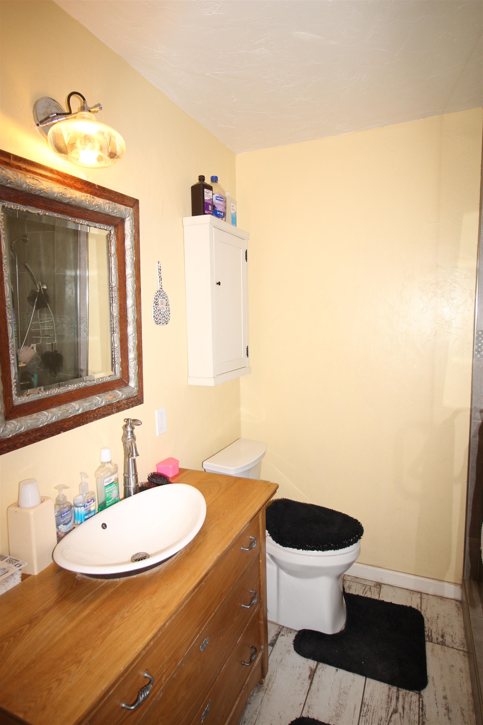 1150 East 7th Street Delta, CO 81416 - Photo 7 of 32 a bathroom with a sink and a mirror