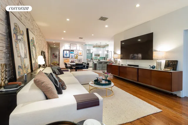a living room with furniture a rug and white walls