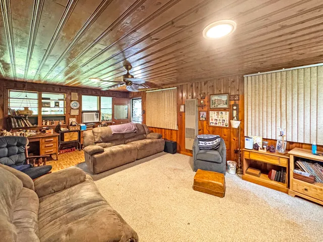 a living room with furniture a fireplace and large window