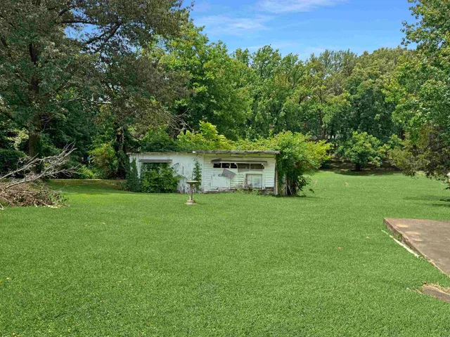 a front view of a house with yard and garage