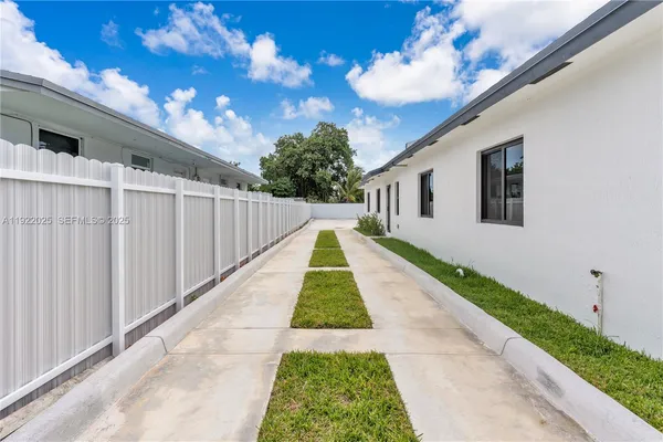 a view of backyard with plants and a small yard