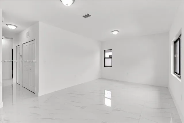 a view of empty room with windows