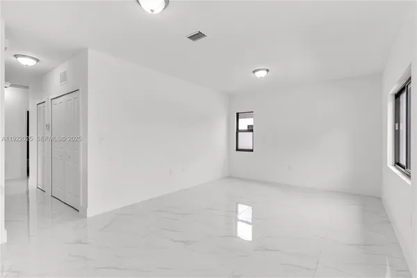 a view of empty room with windows