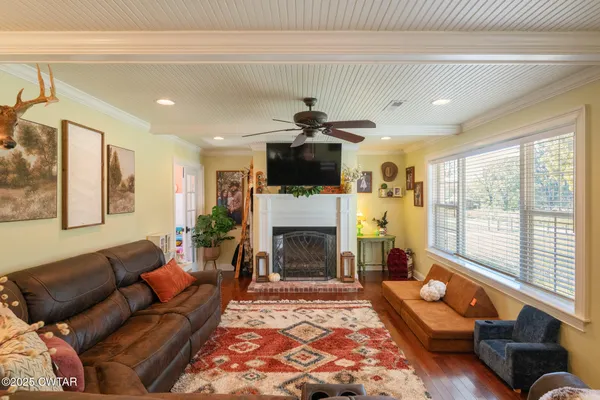 a living room with furniture fireplace and flat screen tv