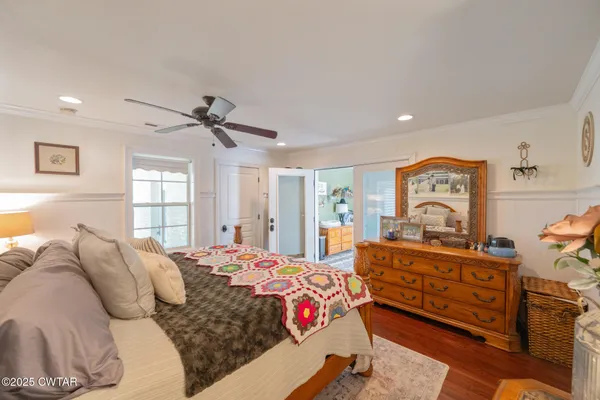 a bedroom with a bed window and dresser