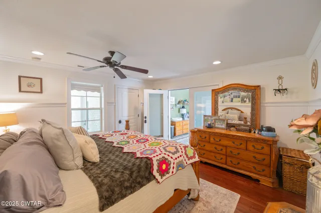 a bedroom with a bed window and dresser