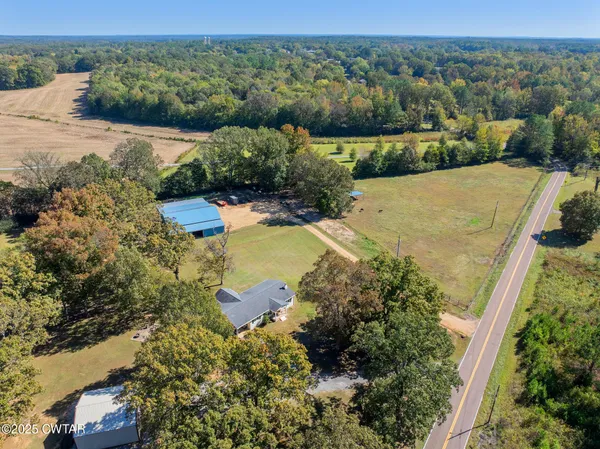 an aerial view of a house with a yard