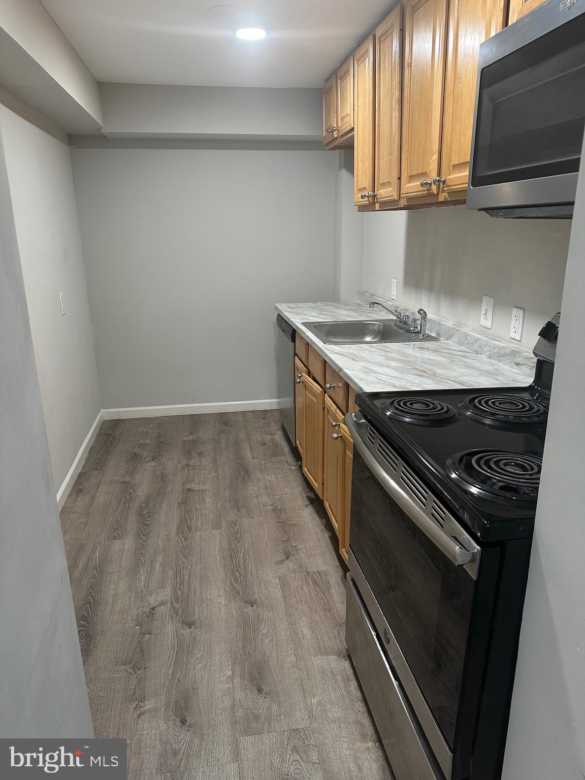 1125 St Paul Street Baltimore, MD 21202 - Photo 2 of 9 a kitchen with a stove and a sink