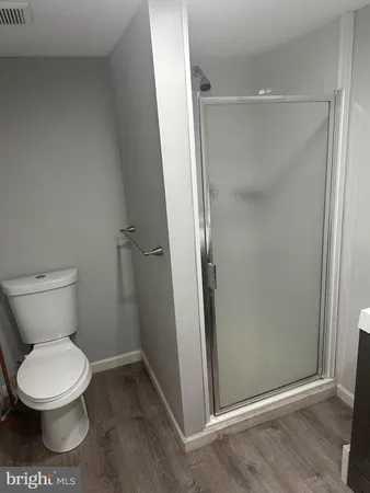 a bathroom with a toilet and a shower