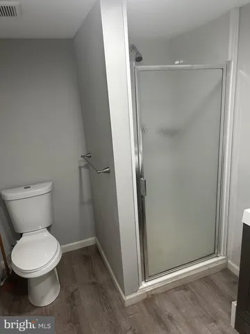 a bathroom with a toilet and a shower