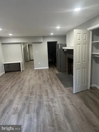 a view of a hallway with wooden shelves