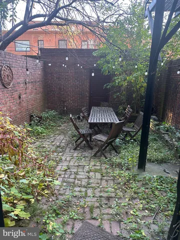 a front view of a house with a yard and fountain