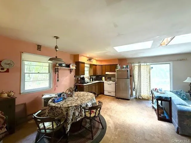 a dining room with furniture and window