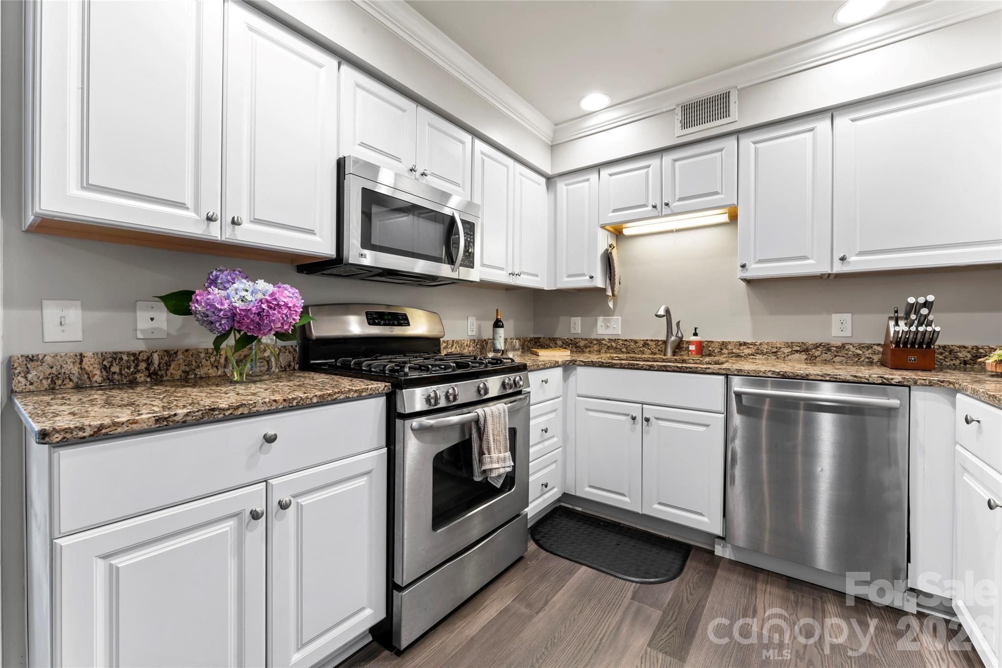 3520 Colony Road, Unit D Charlotte, NC 28211 - Photo 3 of 25 a kitchen with stainless steel appliances granite countertop a sink and cabinets