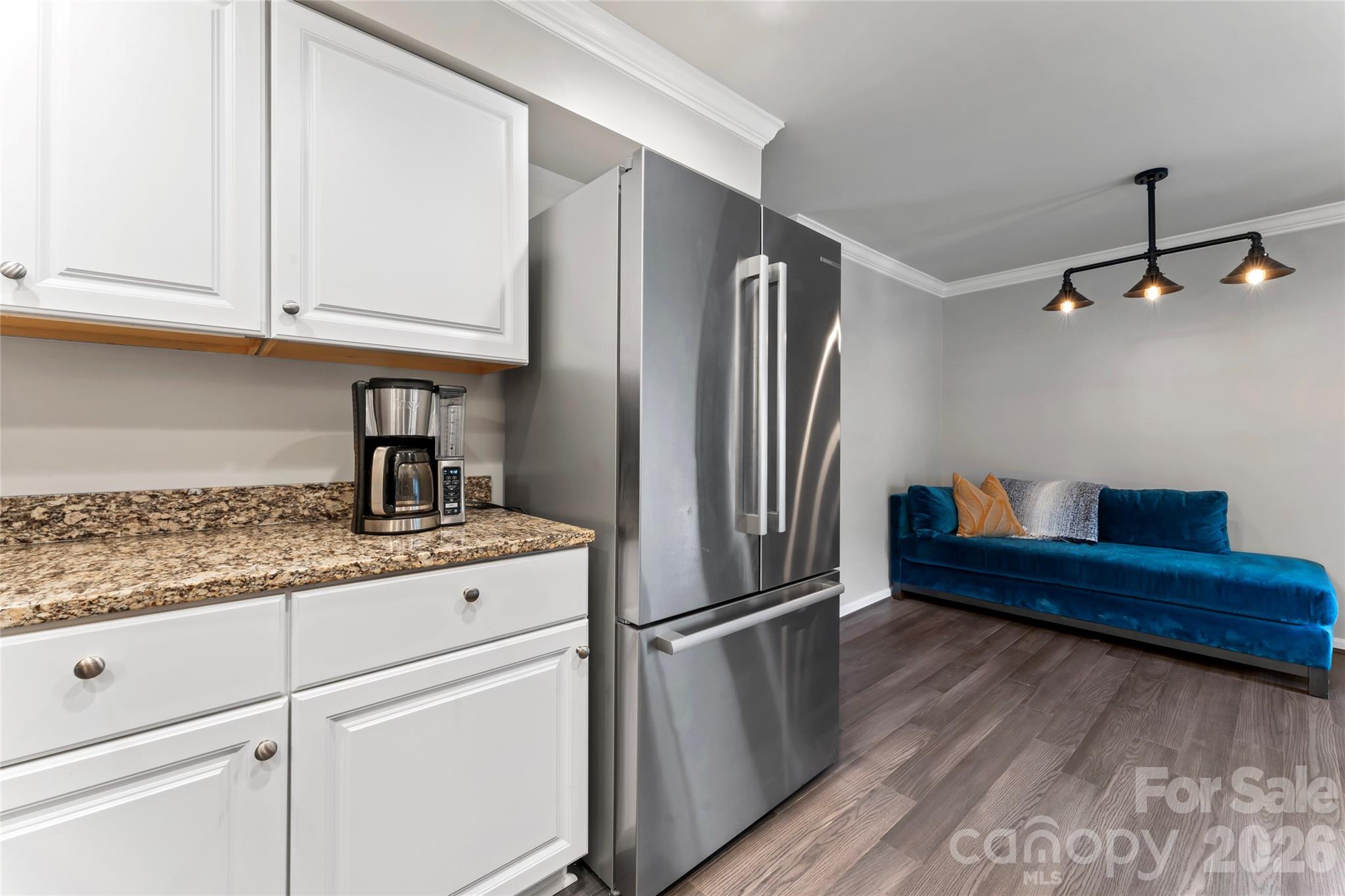 3520 Colony Road, Unit D Charlotte, NC 28211 - Photo 5 of 25 a kitchen with stainless steel appliances granite countertop a refrigerator a sink and white cabinets
