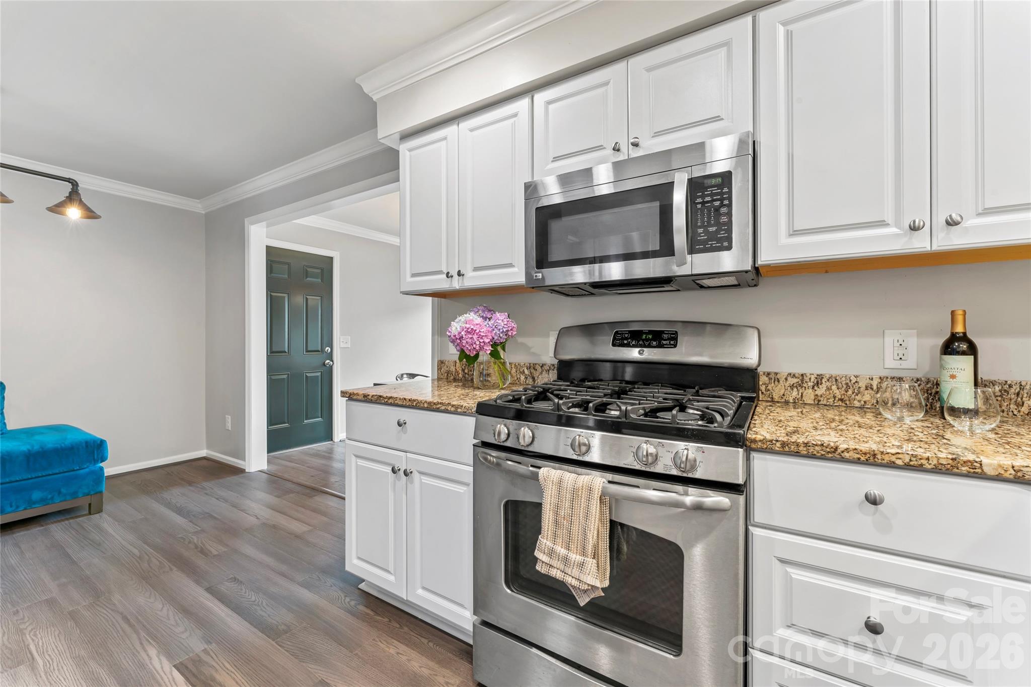 3520 Colony Road, Unit D Charlotte, NC 28211 - Photo 6 of 25 a kitchen with stainless steel appliances granite countertop a stove a microwave oven cabinets and wooden floor
