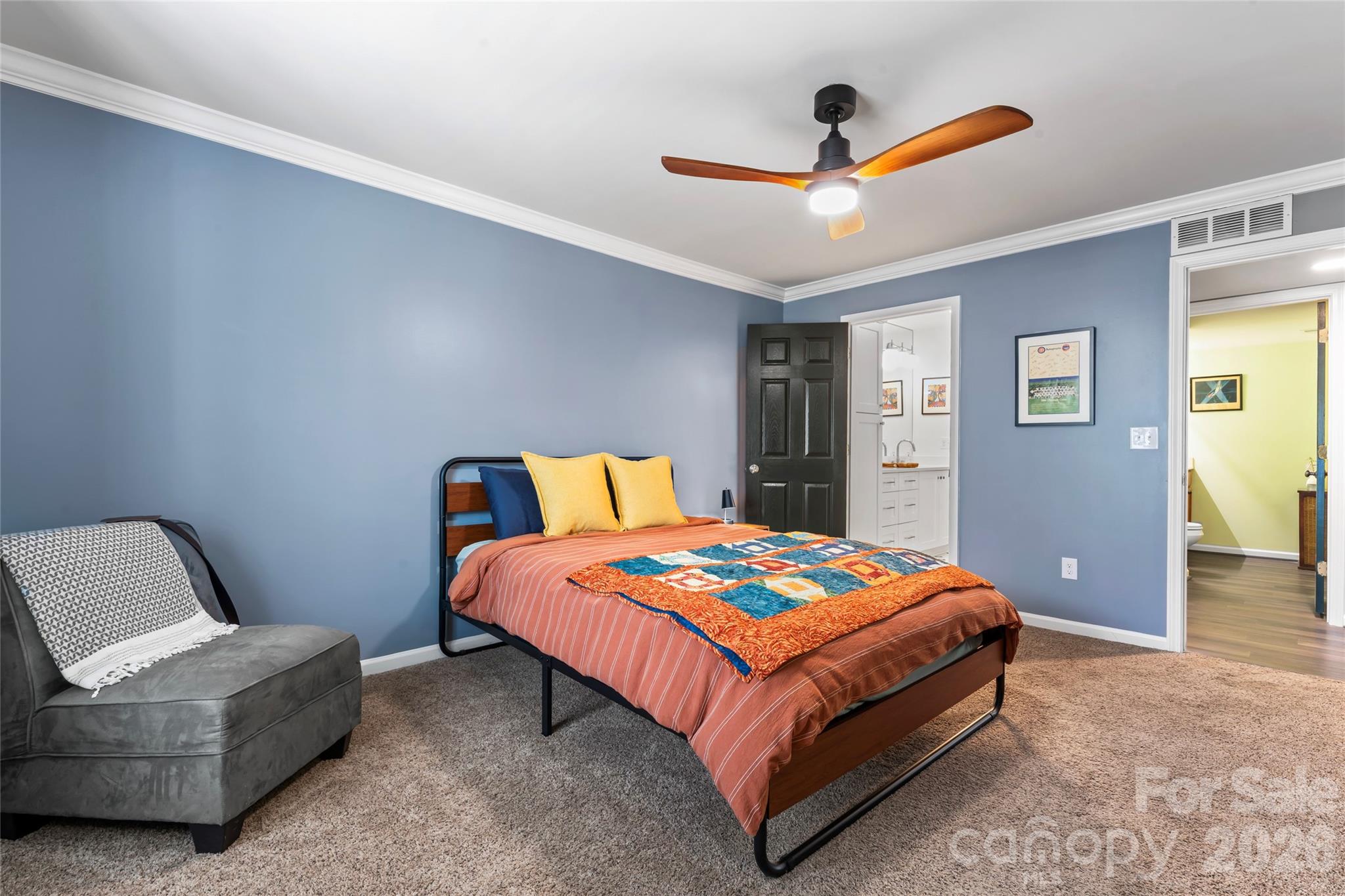 3520 Colony Road, Unit D Charlotte, NC 28211 - Photo 10 of 25 a bedroom with a bed and a chandelier