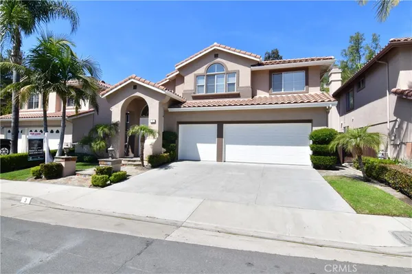 a view of a house with a yard and palm trees