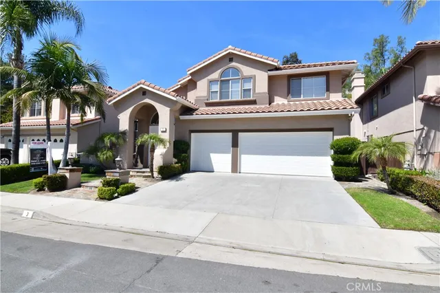 a view of a house with a yard and palm trees