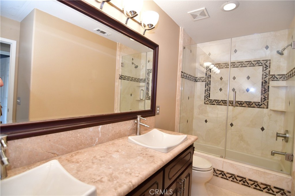 3 Ei Corzo Rancho Santa Margarita, CA 92688 - Photo 19 of 31 a bathroom with a granite countertop sink and a mirror