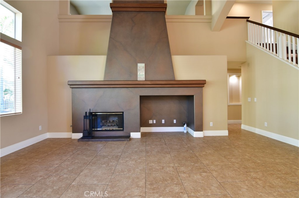 3 Ei Corzo Rancho Santa Margarita, CA 92688 - Photo 21 of 31 an empty room with a fireplace and window