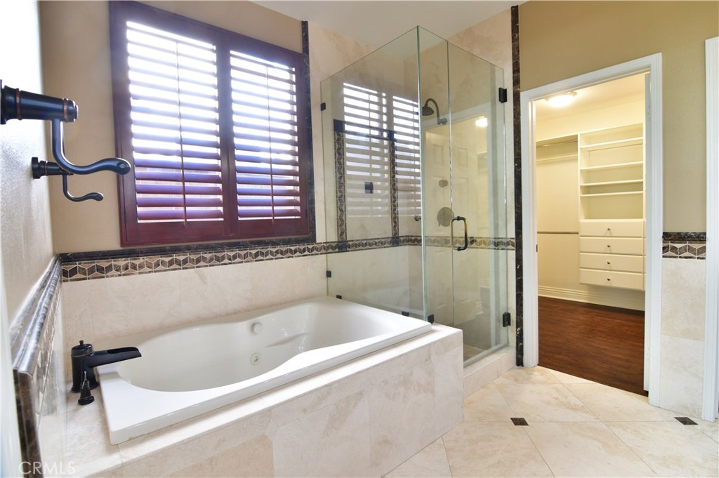 3 Ei Corzo Rancho Santa Margarita, CA 92688 - Photo 27 of 31 a bathroom with a bathtub and a shower