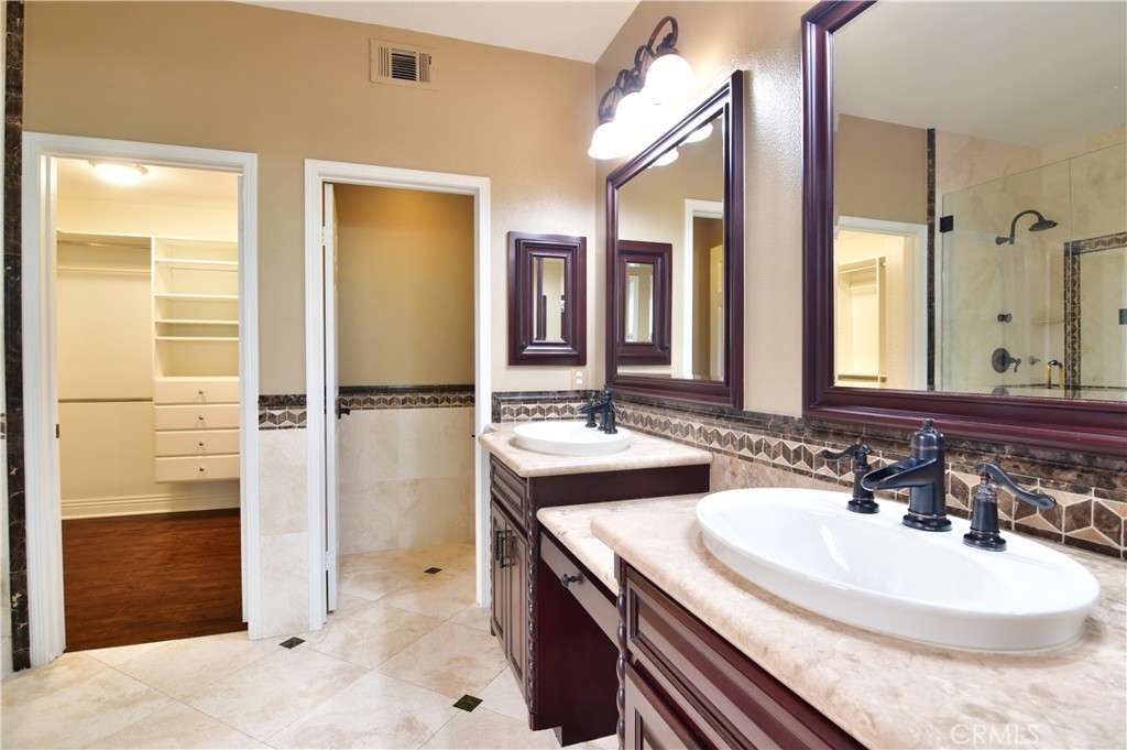 3 Ei Corzo Rancho Santa Margarita, CA 92688 - Photo 28 of 31 a bathroom with a sink a toilet and shower