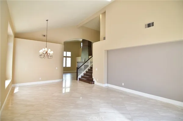a view of a room with stairs and a chandelier fan