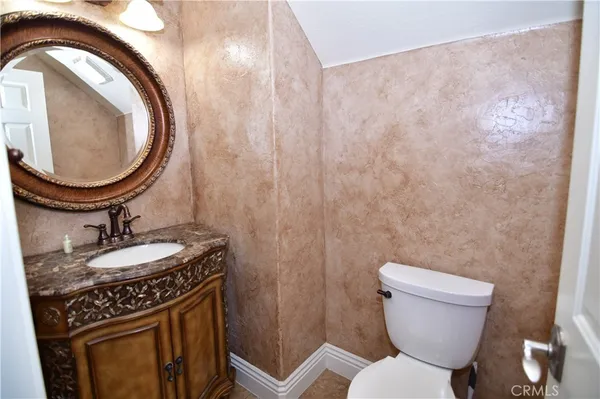 a bathroom with a toilet a sink and a mirror